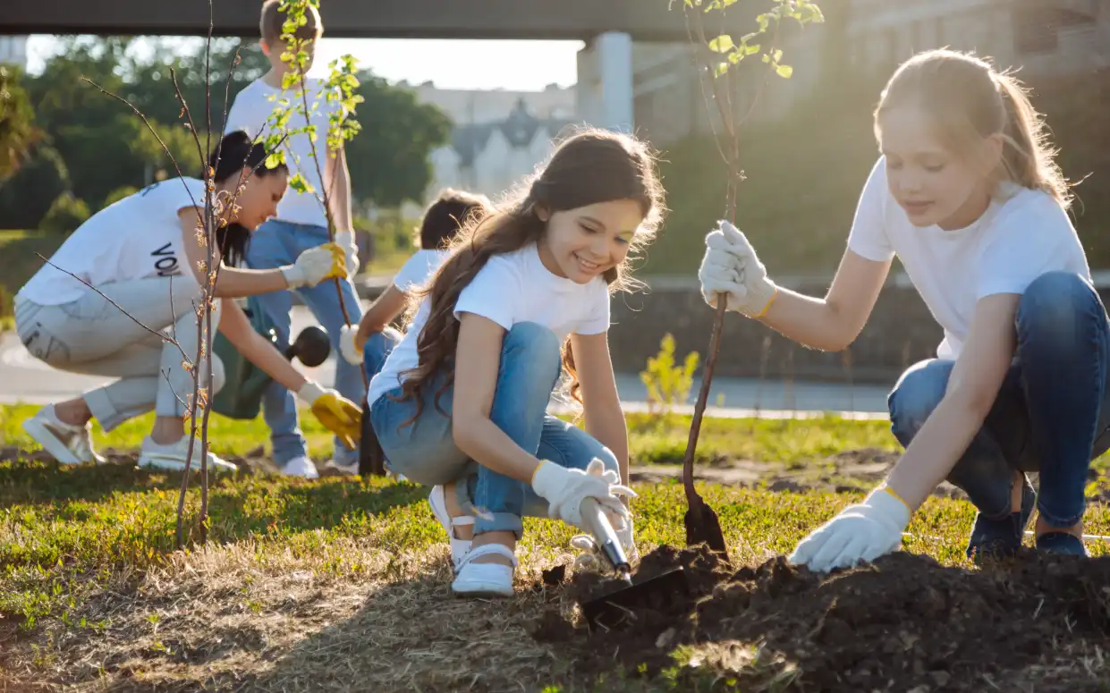 A Group of kids planting trees.