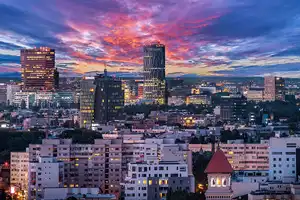 Bucuresti-Ilfov solar power Bucharest cityscape at sunset.